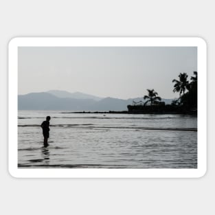Boy walking through water in low tide Sticker